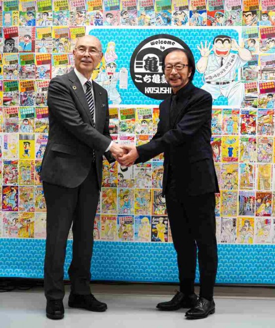 Osamu Akimoto, smiling with clenched fists